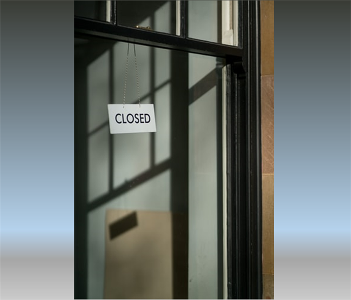 glass door with a closed sign